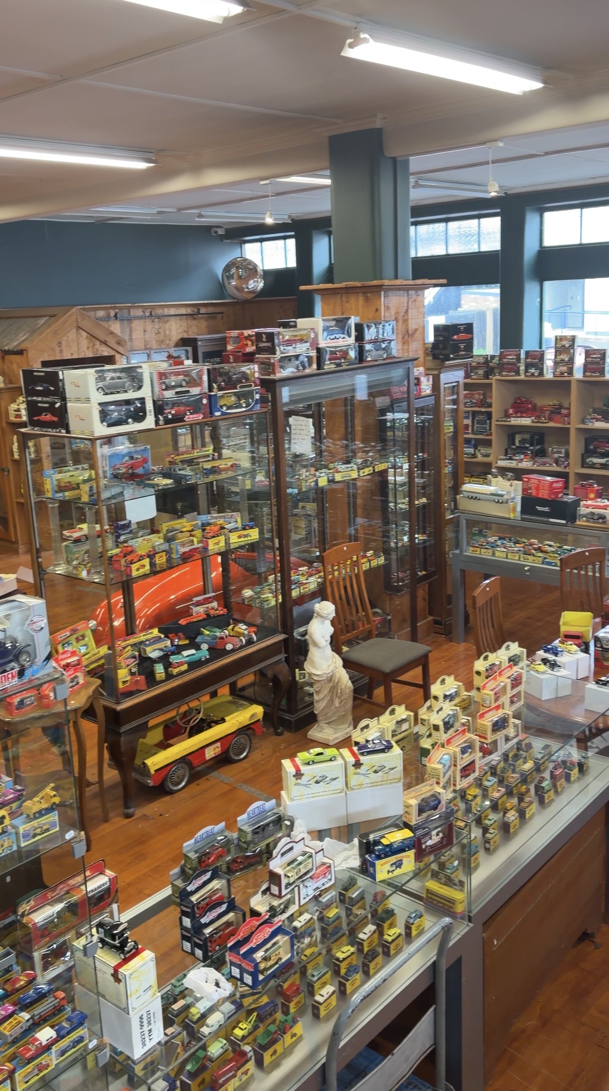 Boxed Matchbox and diecast toy collection in display cabinets