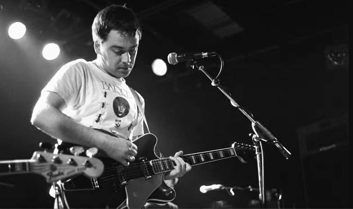 Proctor Auctions — Auction 227, The Estate of the great Martin Phillipps, black and white photo of Martin Phillipps performing on stage
