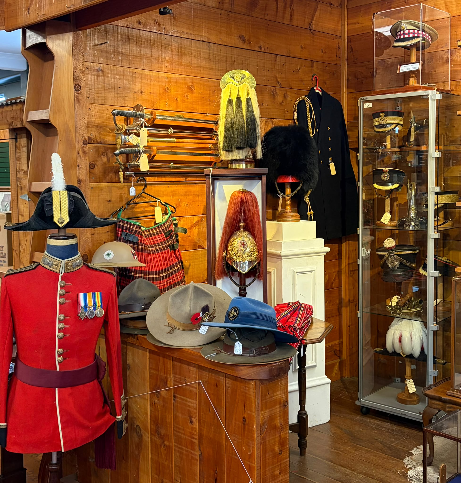 Militaria display — medals, red uniform, kilts